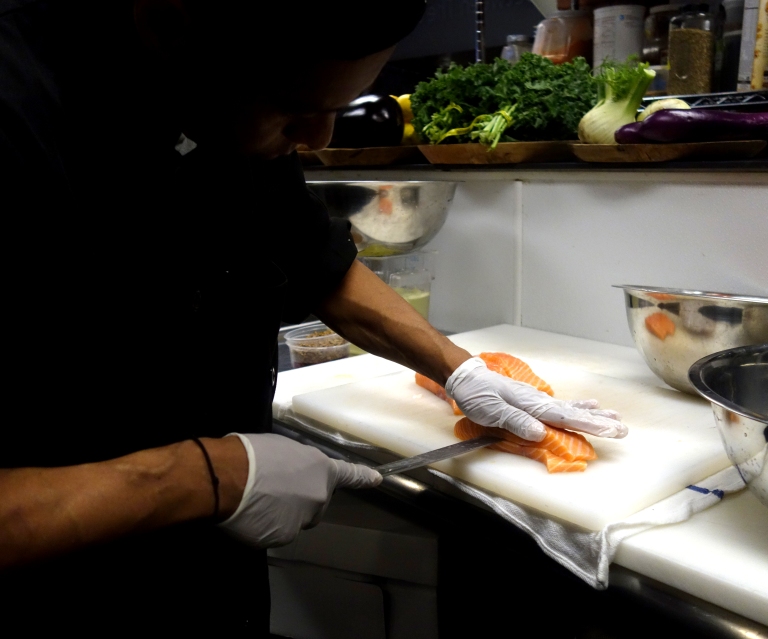 Chef Juan slicing open half the salmon for stuffing